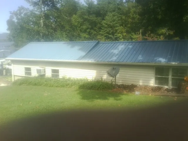 Blue metal roof running the length of a single story home in Hamptonville